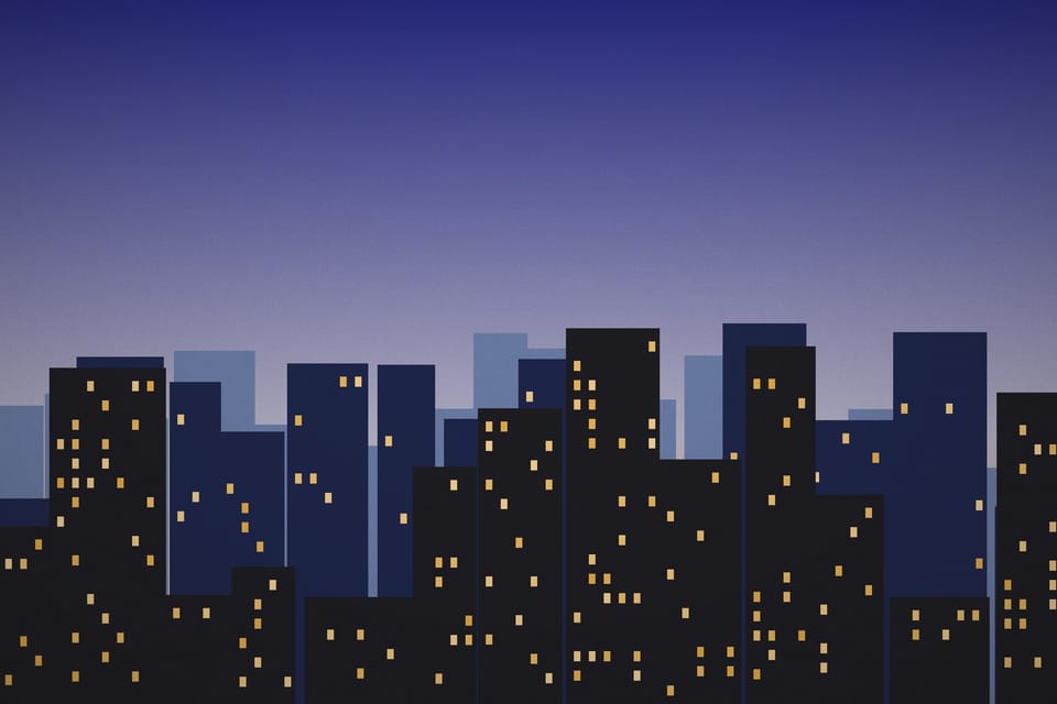 A skyline at dusk with lit windows