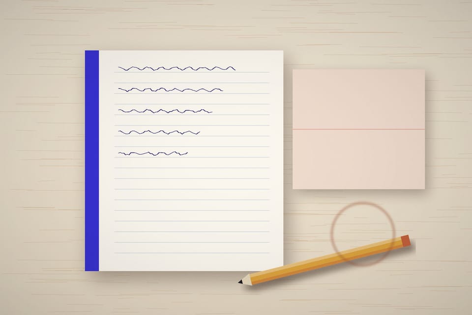 A notebook, folded sheet and pencil on a pale wooden desk